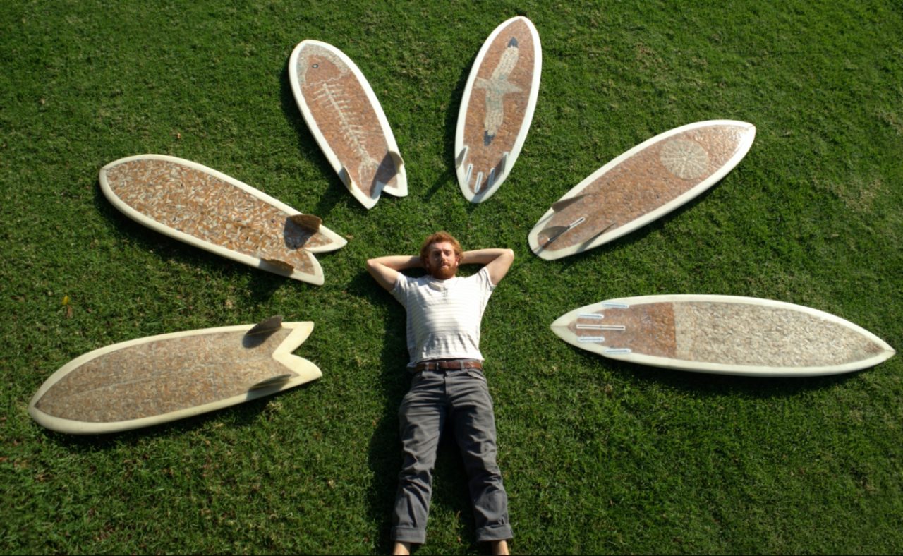 Ciggy Board builder Taylor Lane surrounded by his surfboards