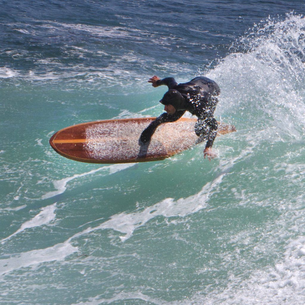 Tyler Fox carving the waves on a Ventana surfboard