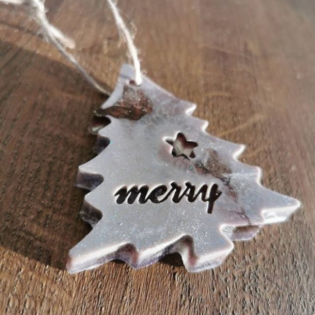 The smooth, creamy finish with a subtle dusting of fine glitter provides excellent contrast so that the word "merry" really stands out on this elegant ornament.