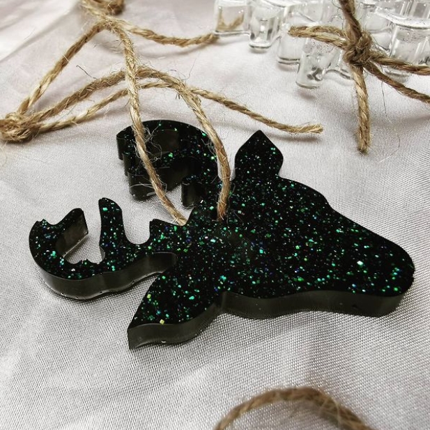 The deep green color of this epoxy-casted reindeer head is accented with bright green glitter that sparkles like crushed emeralds.