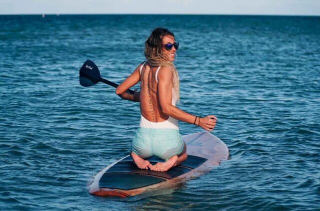 Girl kneeling on paddleboard