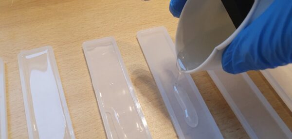 pouring resin into bookmark moulds
